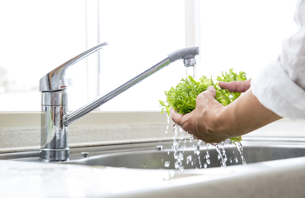 WFA - A woman cleaning a lettuce with tap water